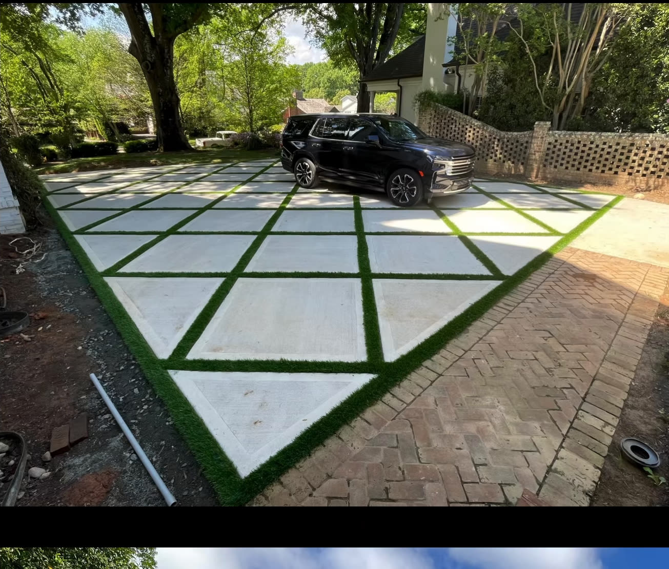 Concrete paver driveway with turf joints in a diamond pattern